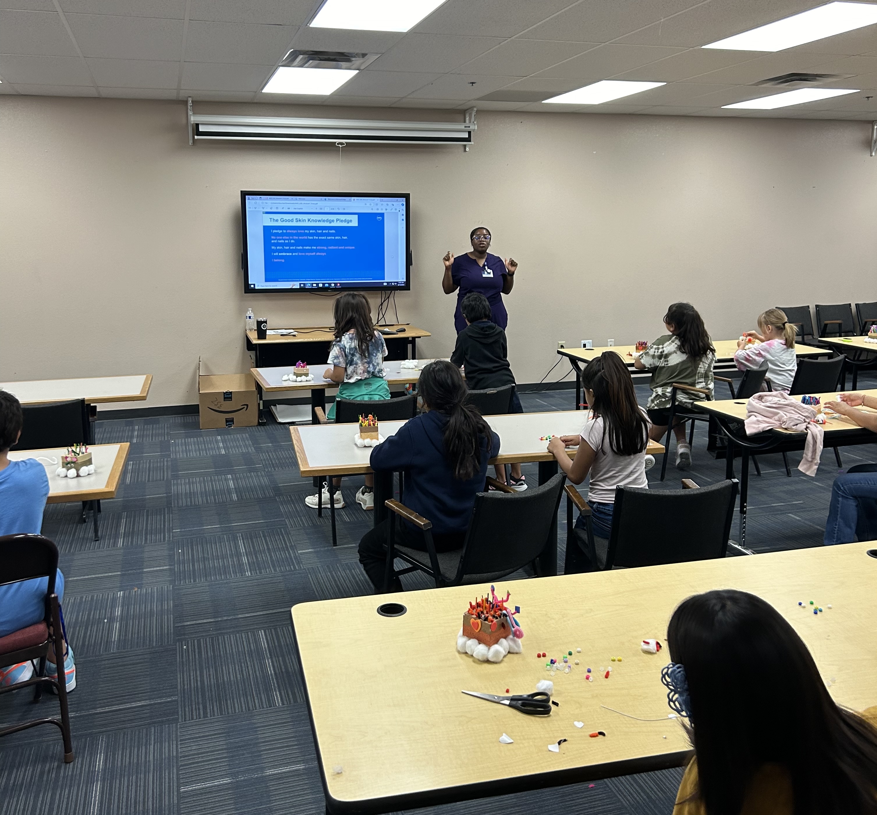 A health educator leading a workshop with students in a classroom